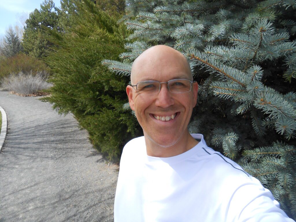 jim tolles, white shirt, evergreens, dirt path